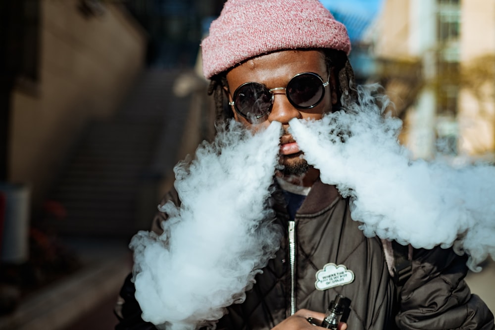 man getting out of smoke on his nose