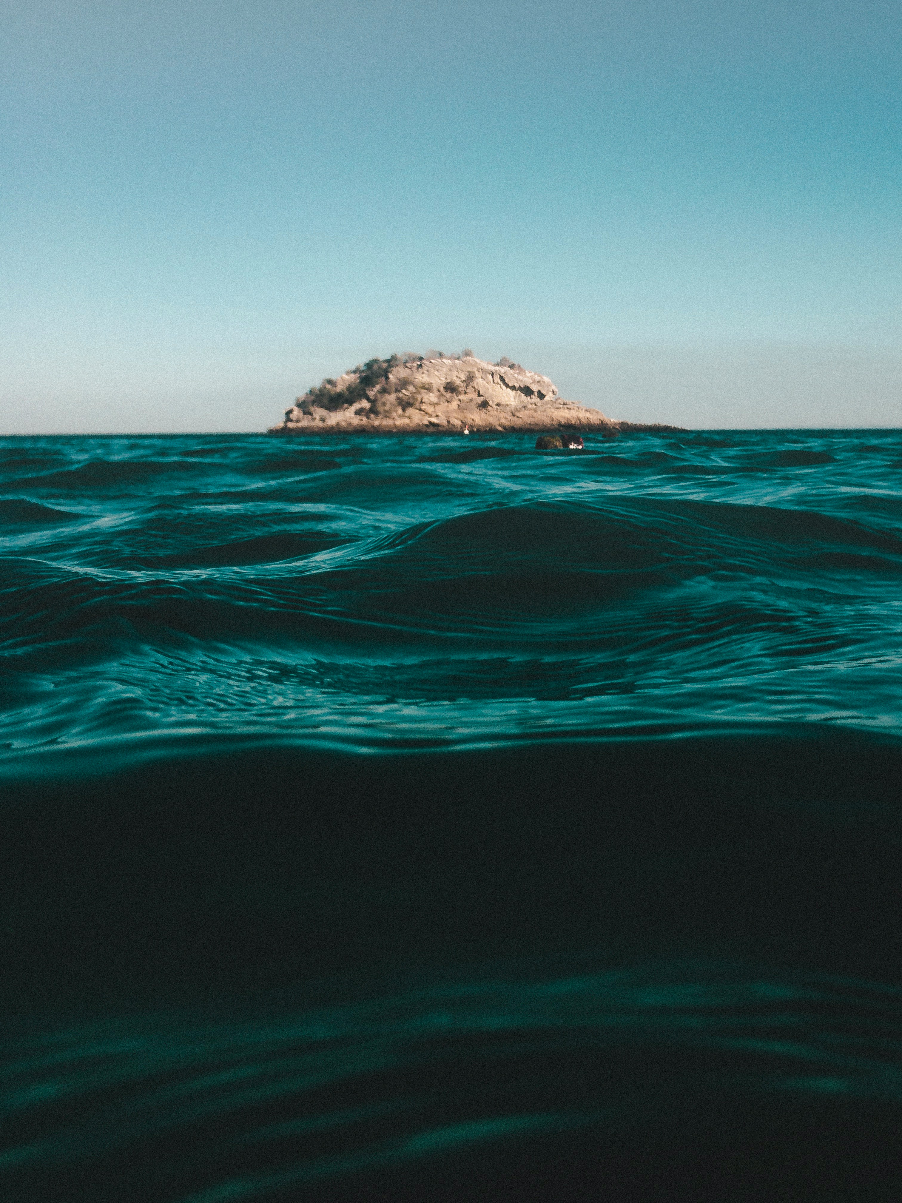 islet on ocean during daytim