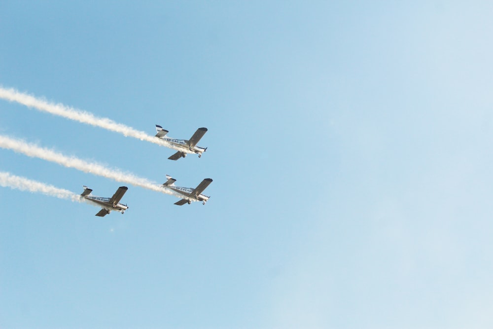 three gray jets flying during daytime