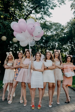 A vibrant group of women running together in a park.