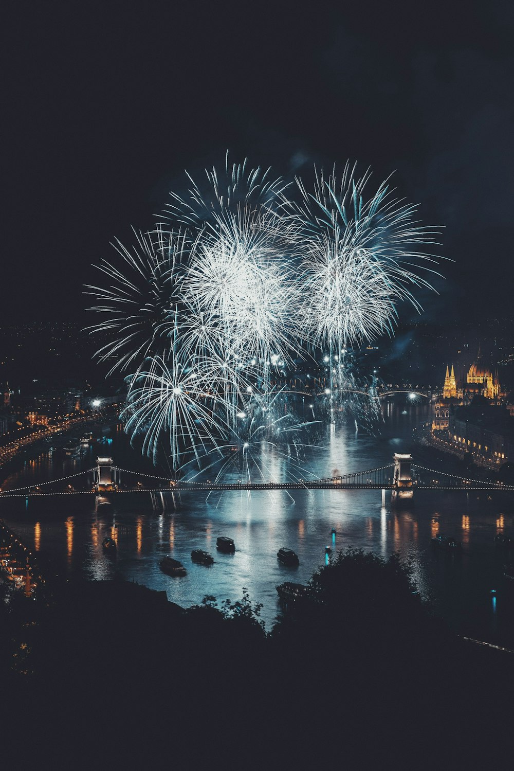 fireworks over bridge during nighttime