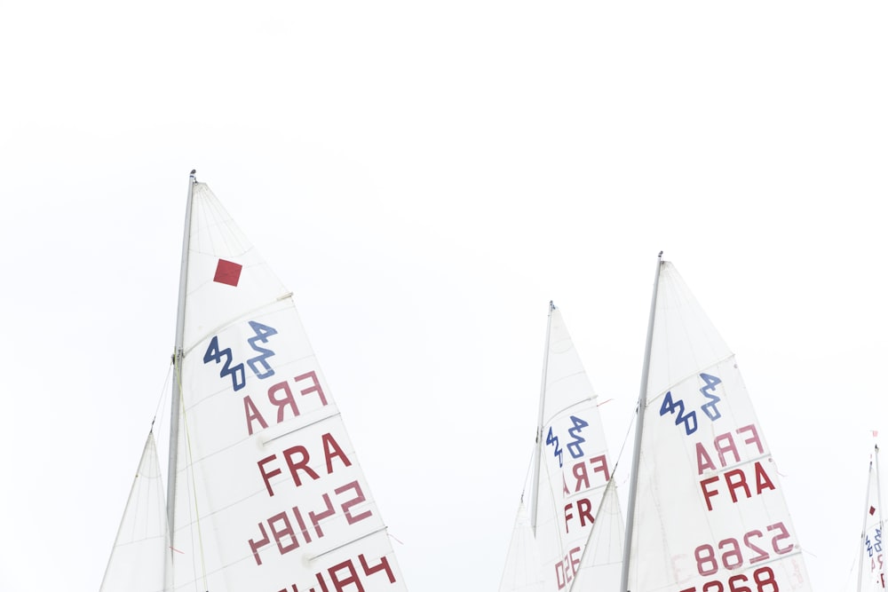 white and red sailboat sails