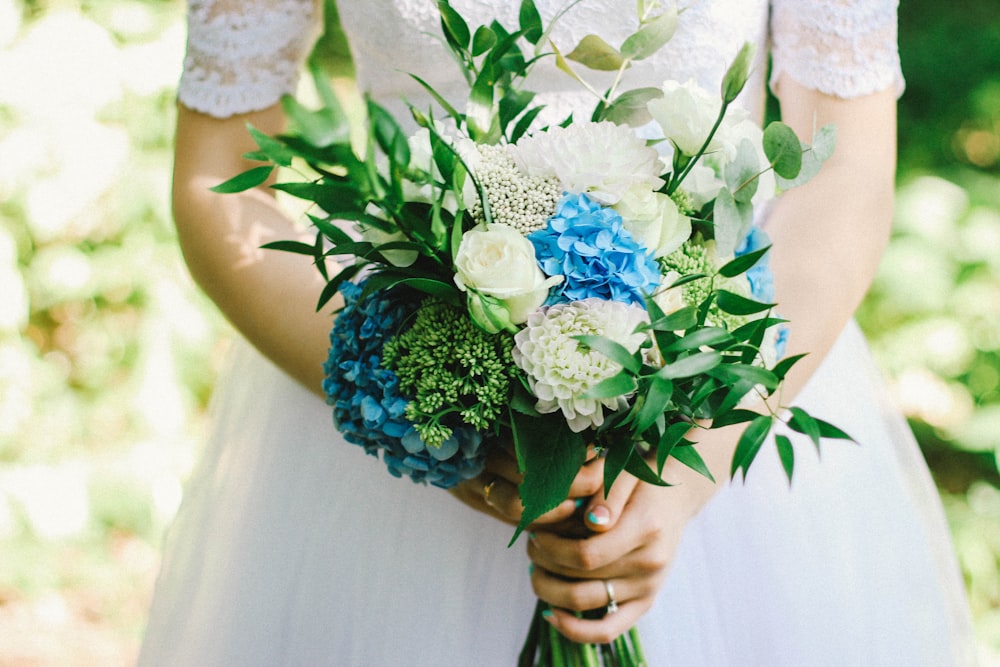 woman holding bouquet of flowers