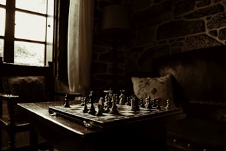 A peaceful room with soft lighting and a chessboard mid-game.