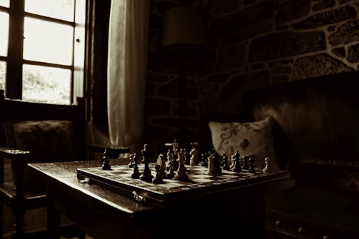 A peaceful room with soft lighting and a chessboard mid-game.