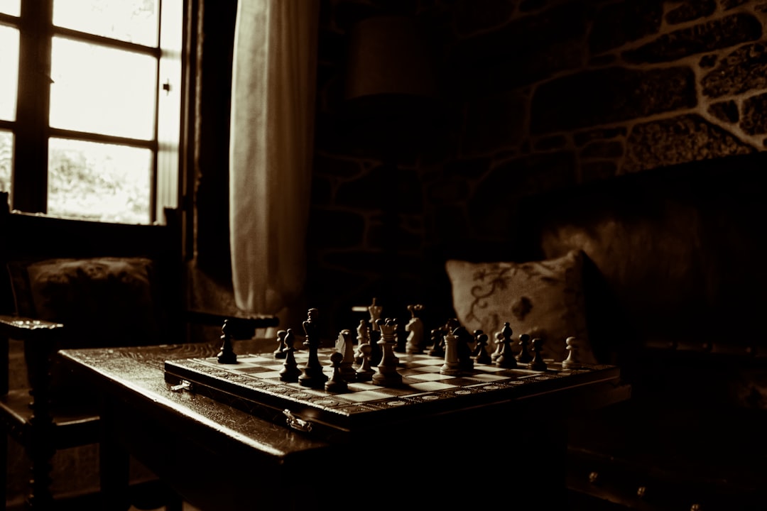  chessboard on table beside window ironing board