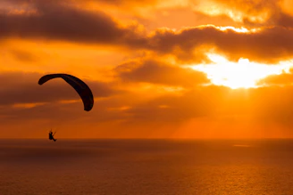 Paramotor flight over the stunning coastline of Arraial do Cabo at sunset.