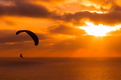Paramotor flight over the stunning coastline of Arraial do Cabo at sunset.