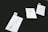 Three clothing tags with the words 'Made Wild' and 'Denver, CO' are arranged on a dark surface. The tags include size options with 'M' circled in red. Each tag has a small illustration of a running fox.