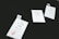 Three clothing tags with the words 'Made Wild' and 'Denver, CO' are arranged on a dark surface. The tags include size options with 'M' circled in red. Each tag has a small illustration of a running fox.