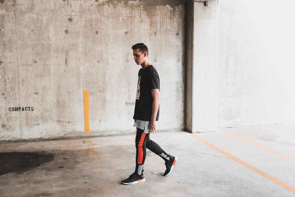 man walking on gray concrete floor