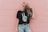 woman standing near pink concrete wall during daytime