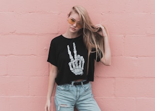 woman standing near pink concrete wall during daytime