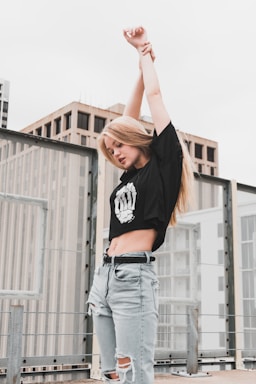 none,how to photograph stretching her arms; woman stretching her arm upward