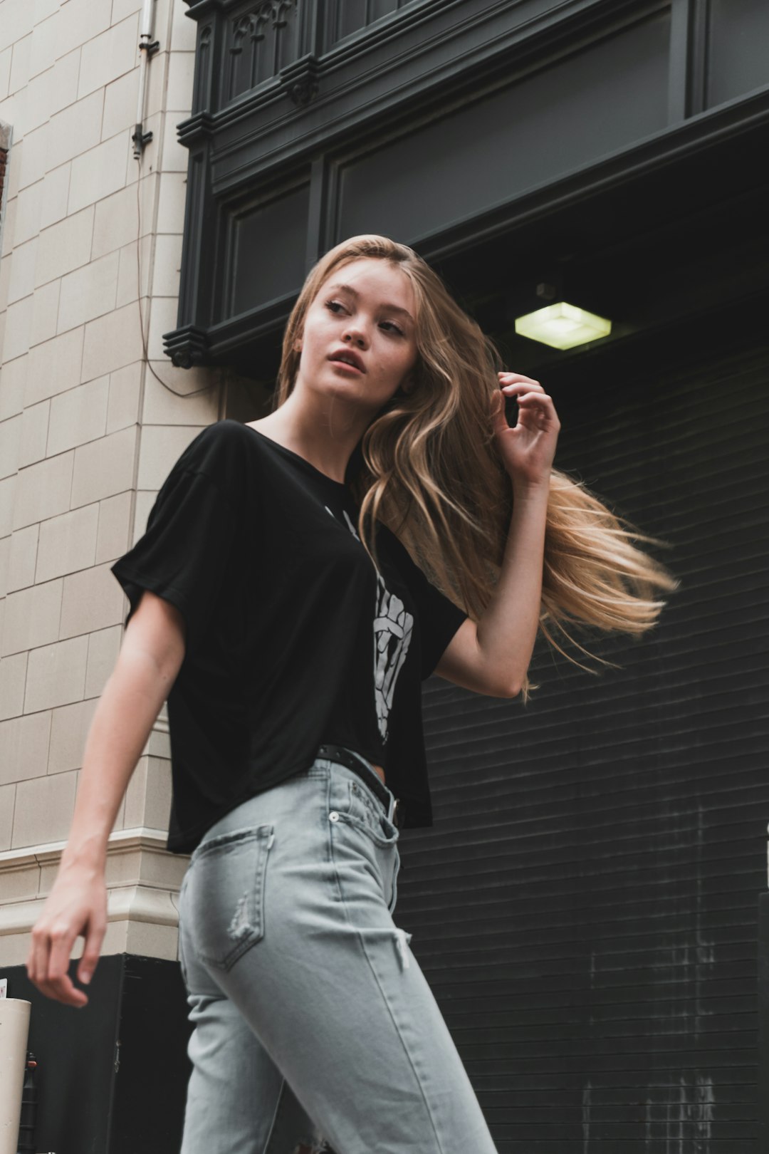 woman walking near building