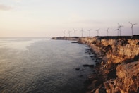 windmill near body of water during daytime