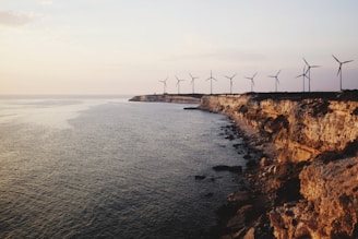 windmill near body of water during daytime