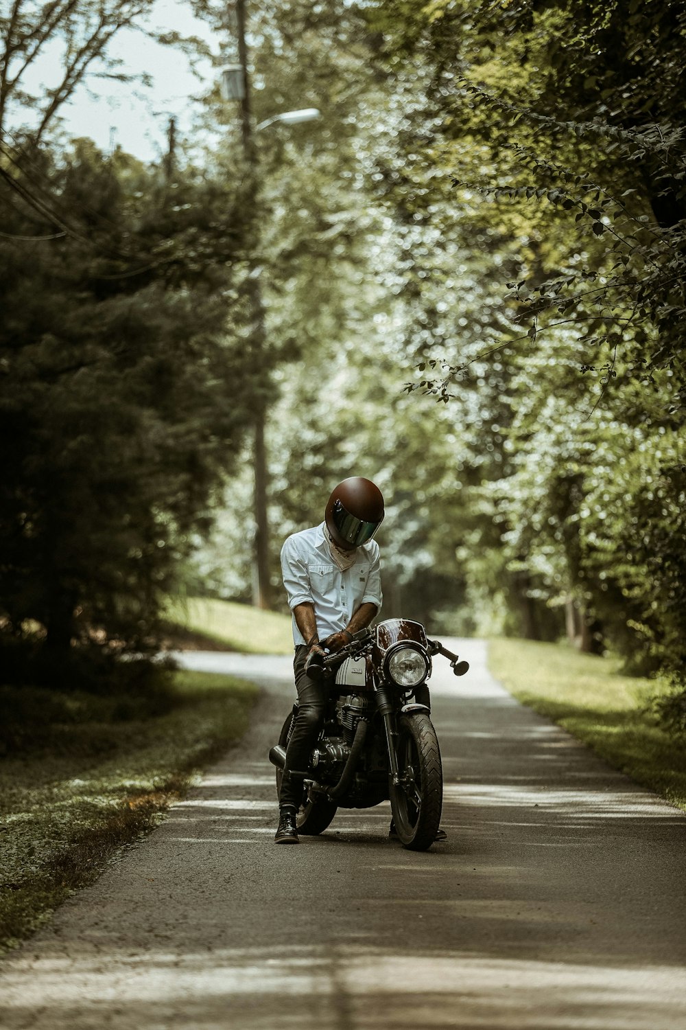 man riding motorcycle on pathway