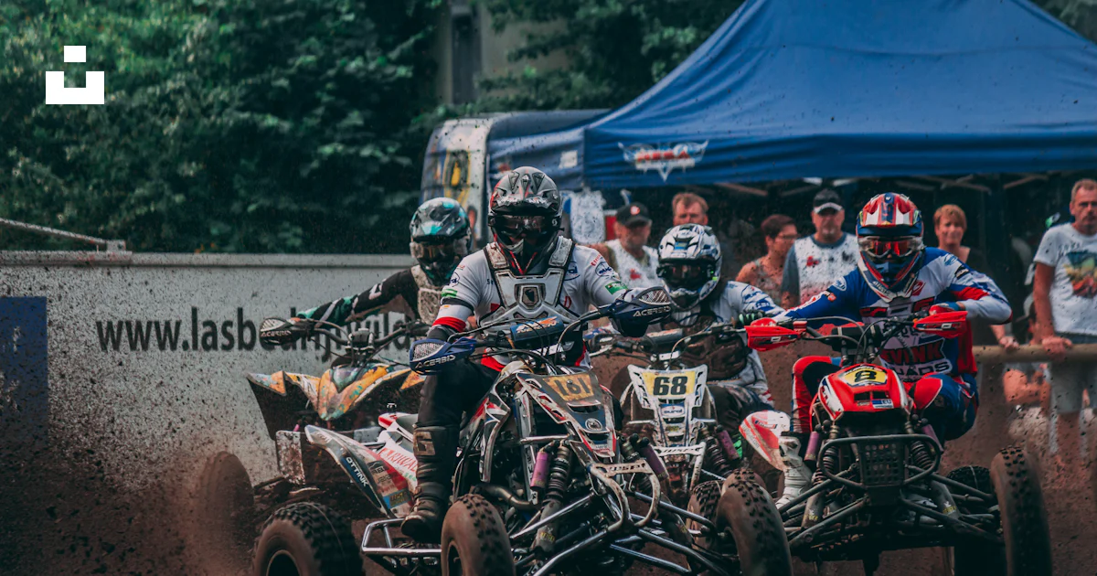 Atv Racers Four men riding ATVs racing on mud with people watching during daytime ...