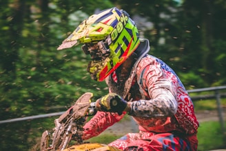 Close-up of a motocross rider kicking up mud in mid-air