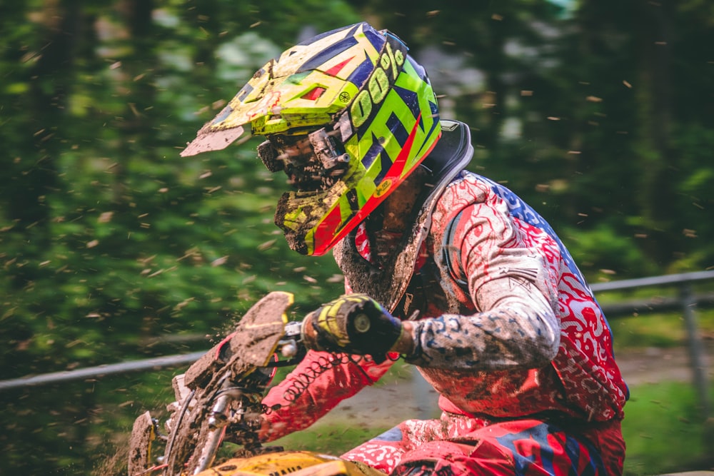 man riding on dirt bike near trees