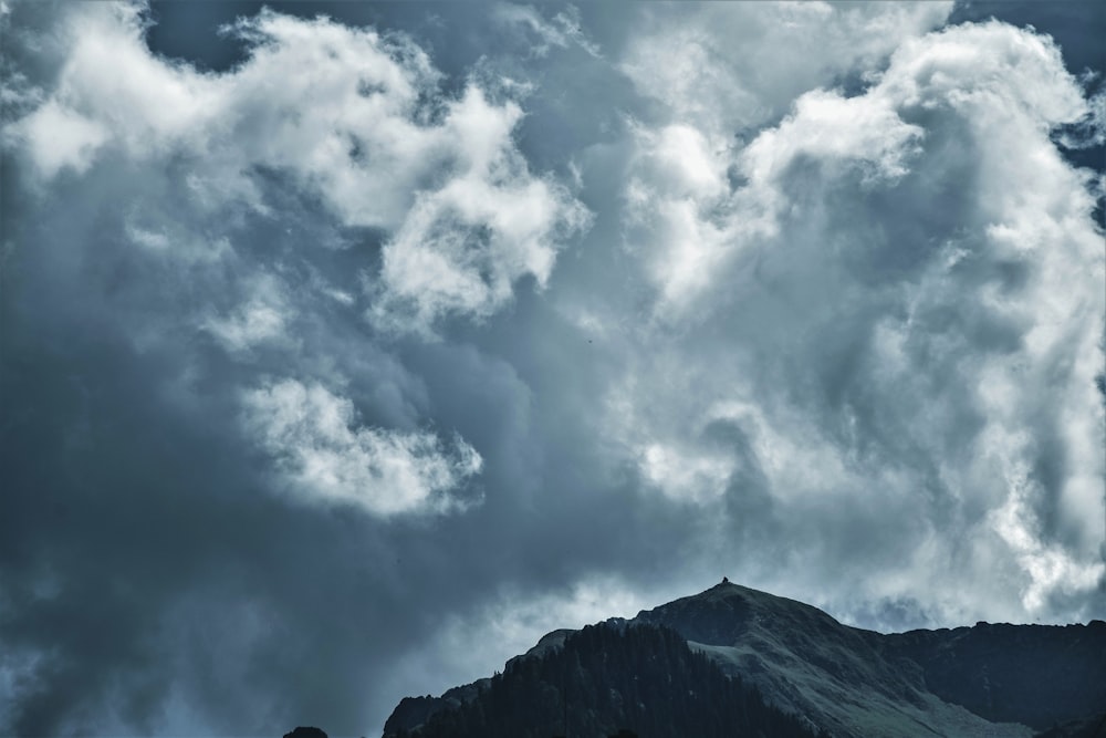 mountain range under cloudy sky