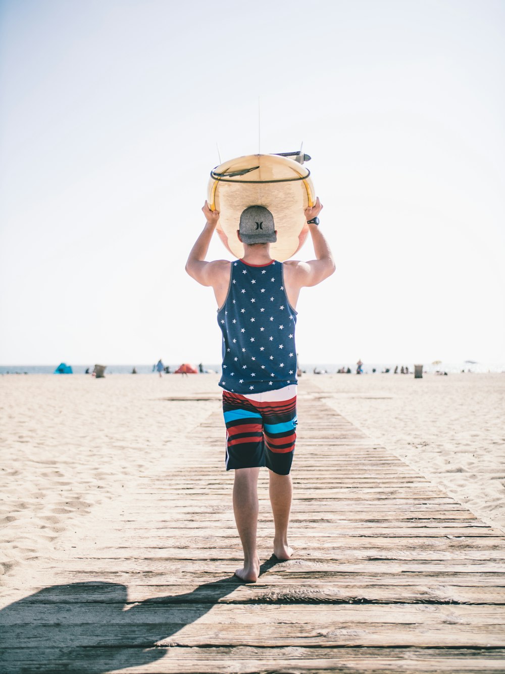 person holding board on body of water