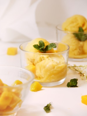 A delicate dessert of mango sticky rice with fresh mint garnish, inviting and fresh.