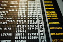 Airport departure board showing flight times
