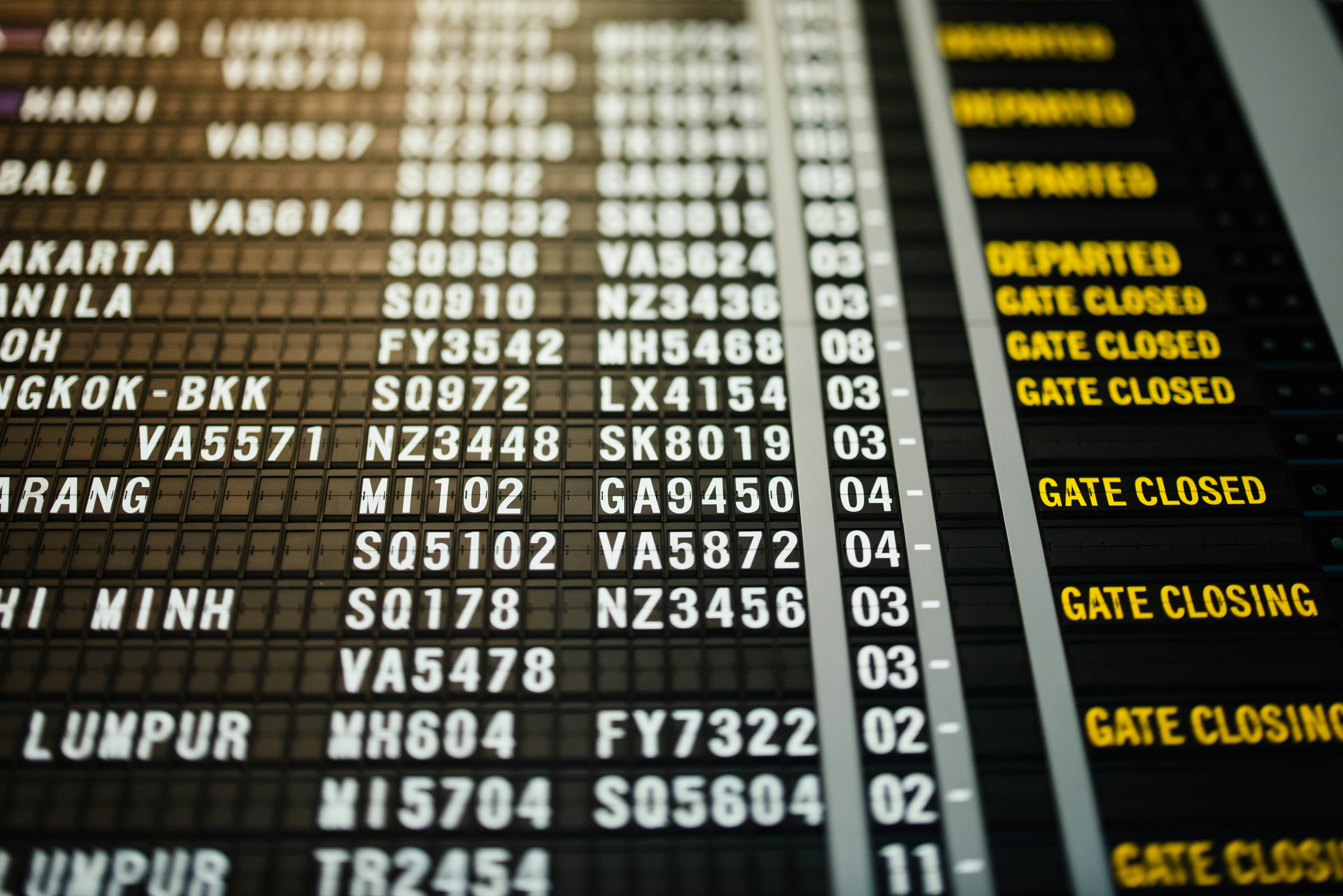 modern airport flight departure display board showing canceled status
