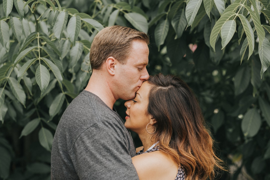 couple hugging near tree leafs, another photo from the shoot shortly after being married
