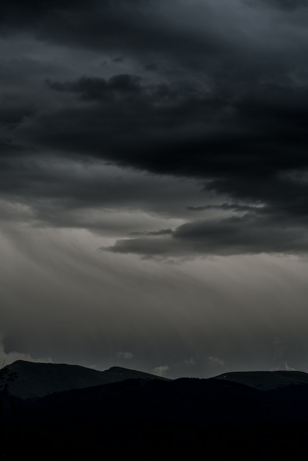 silhouette of mountain under dramatic sky