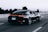 running black Porsche sedan