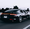 running black Porsche sedan