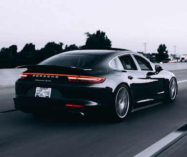 running black Porsche sedan