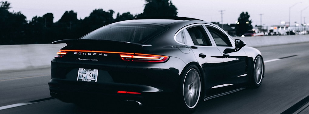 running black Porsche sedan