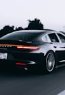 running black Porsche sedan