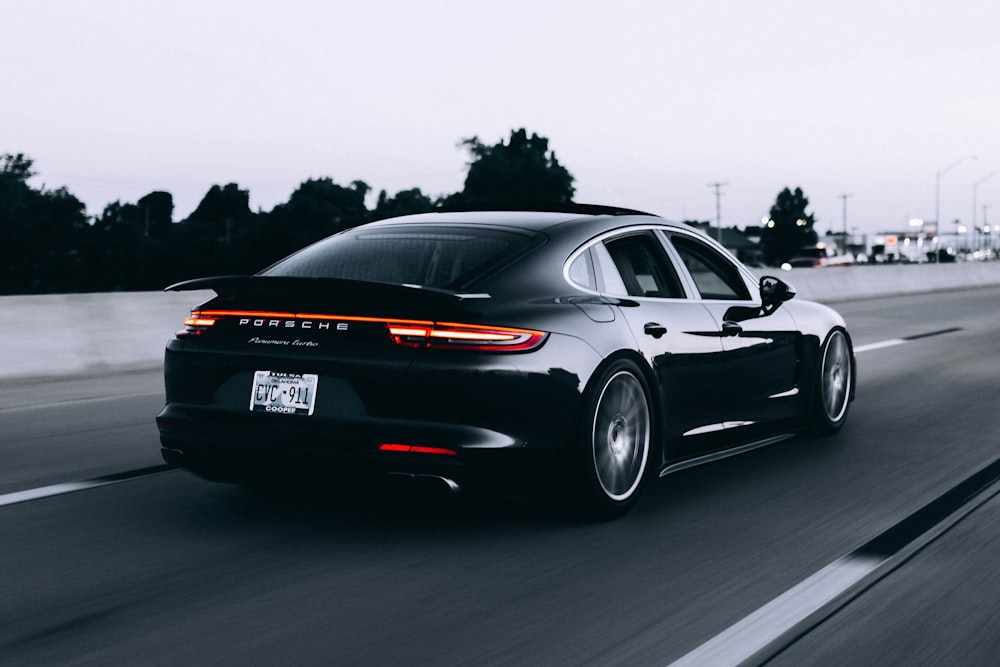 running black Porsche sedan