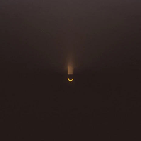 A dark space background with subtle gold light rays highlighting a glowing sigil.