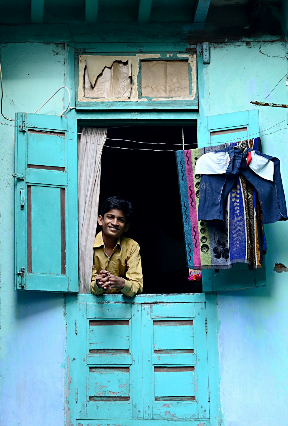 person smiling in window