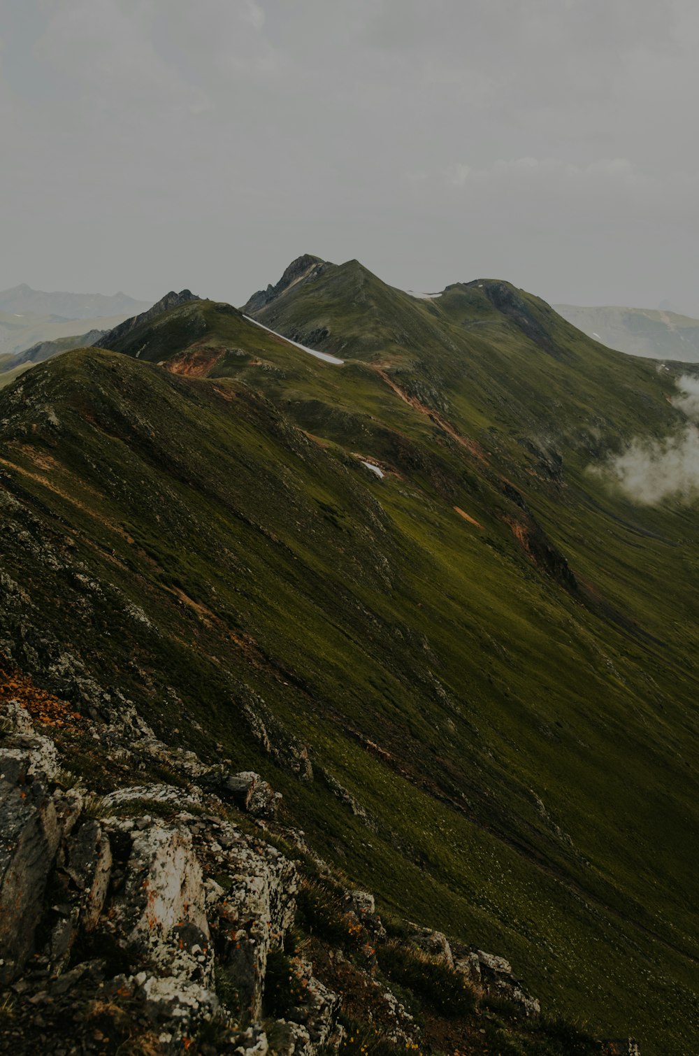 green mountain under cloudy sky