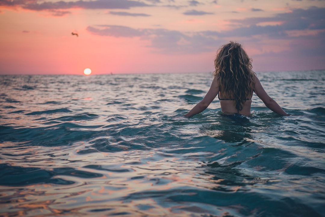 woman swimming on body of water