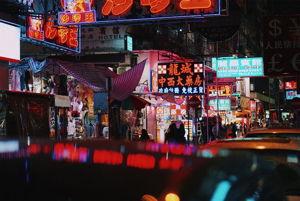 a city street filled with lots of neon signs