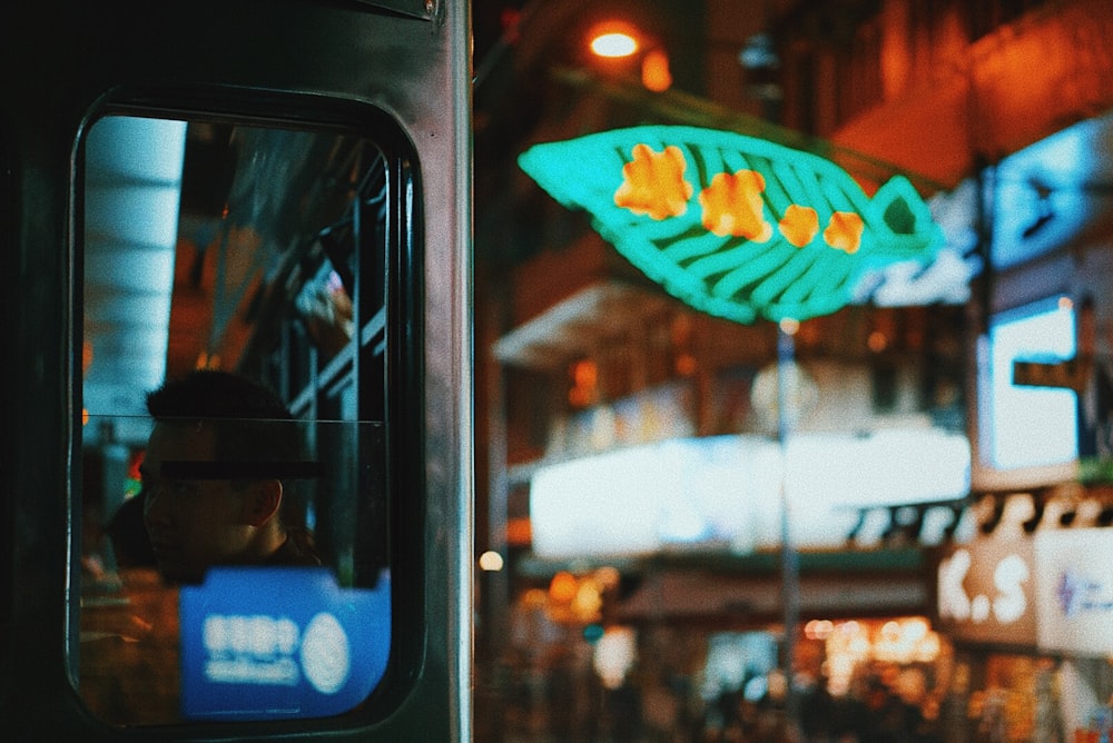 a person sitting on a bus looking out the window