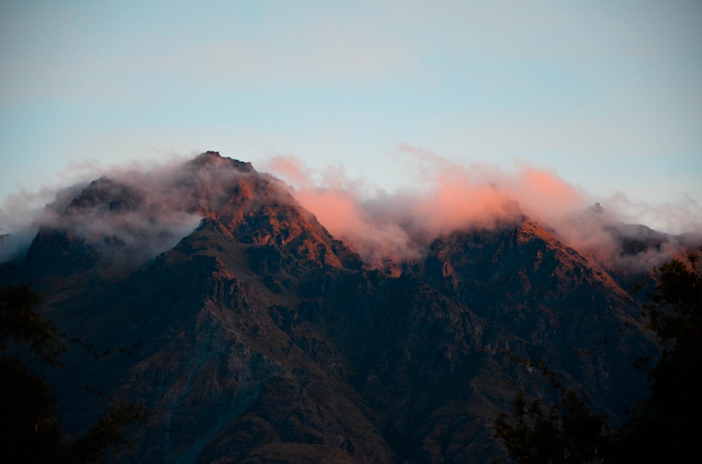 brown mountains surrounded with white fogs