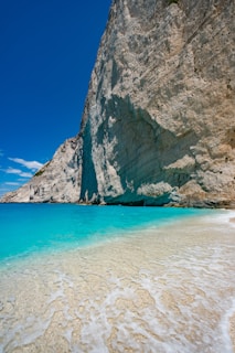A stunning beach landscape with turquoise waters and a clear blue sky.