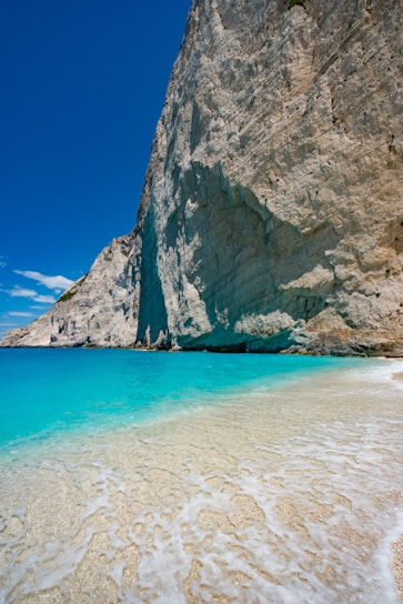 A stunning beach landscape with turquoise waters and a clear blue sky.