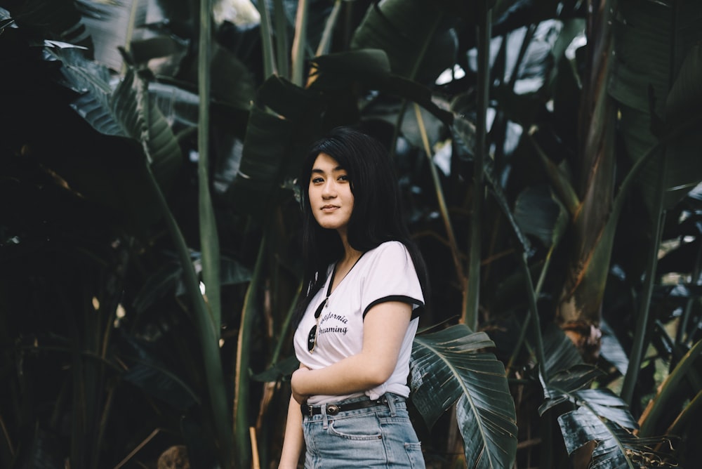 woman standing in front of banana tree at daytime