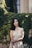 woman standing in front of wall covered by plants