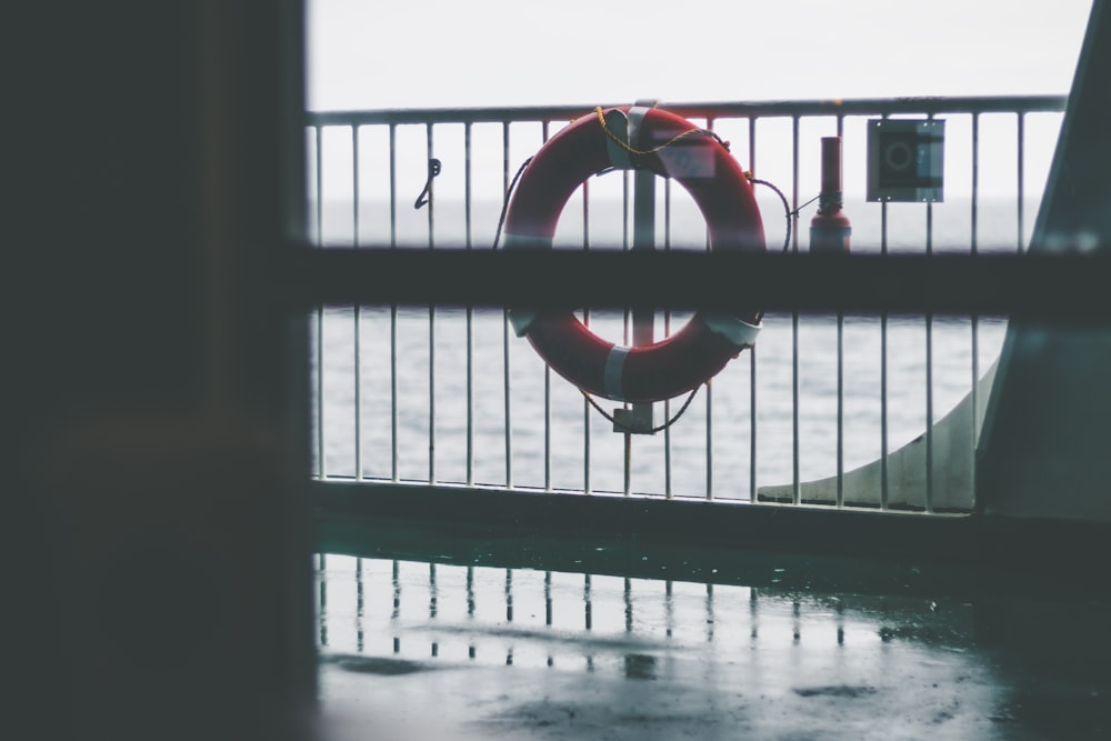 lifesaver ring on gray boat hand rail